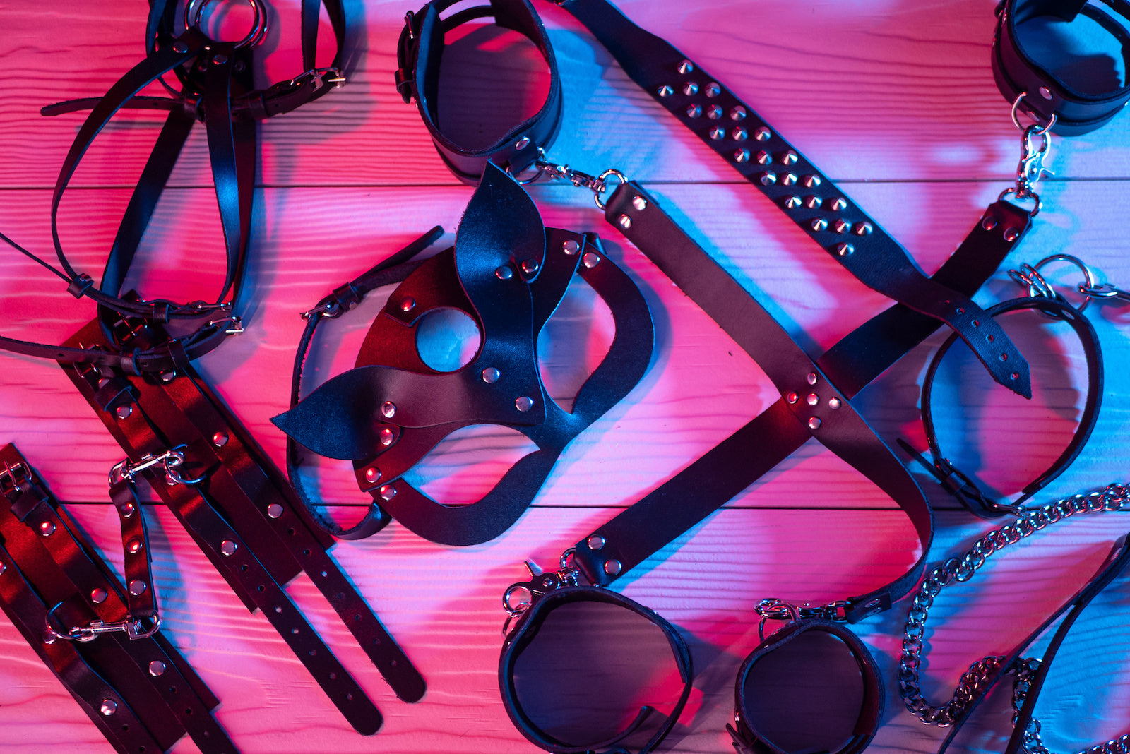 bondage toys BDSM laying on wooden floor 